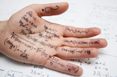 Close-up of a hand covered in formulas for a math class exam